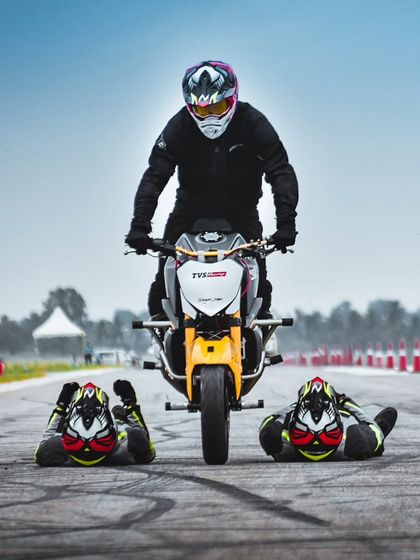 A daring stunt where a rider jumps over two fellow performers lying on the track. This high-risk, high-reward performance always leaves the crowd breathless.