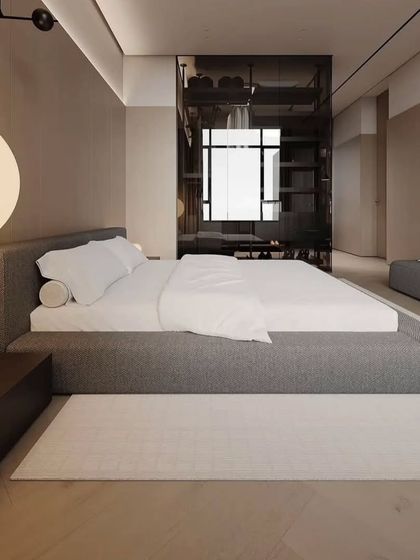 A view of the bedroom's walk-in closet, which is separated by a sleek, smoked glass partition. This adds a touch of modern luxury.