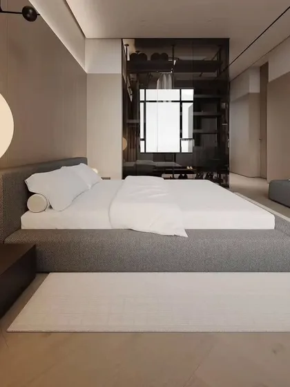 A view of the bedroom's walk-in closet, which is separated by a sleek, smoked glass partition. This adds a touch of modern luxury.