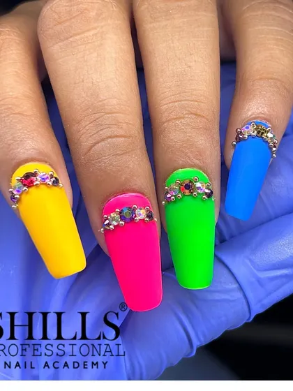 A vibrant set of square-shaped neon nails, with each nail featuring a dazzling rhinestone design at the cuticle.