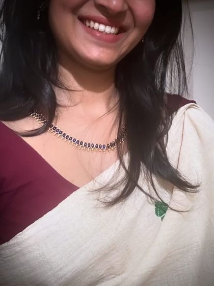 A cropped-in shot showing the details of my smile and traditional jewelry.