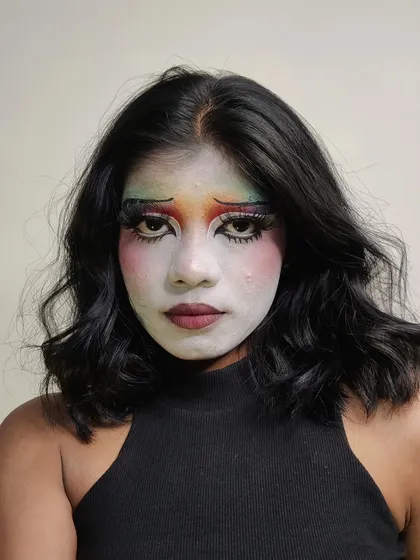 My take on a sad clown or pierrot makeup. I used a white base with rainbow eyeshadow and drooping liner to create a melancholic expression.