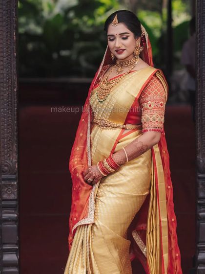This is a quintessential South Indian muhurtham look. I created a flawless base with a bold red lip for Supritha, which stands out beautifully against her golden silk saree and traditional jewellery. The detailed bridal braid completes this timeless look.