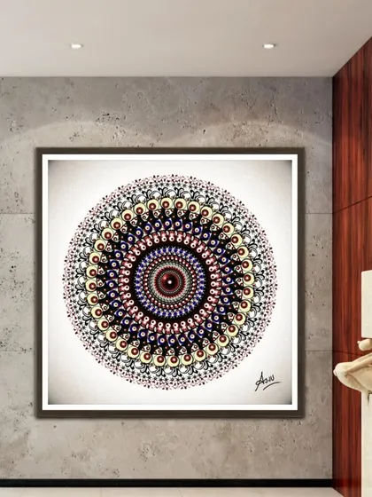 A highly detailed digital mandala, displayed as a large square artwork in a modern hall. The colors are warm and intricate.