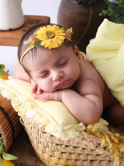 A close-up of pure innocence. This shot focuses on the baby's peaceful expression and tiny features, framed by the soft yellow of our lemon theme. I love capturing these detailed portraits that you'll look back on for years.