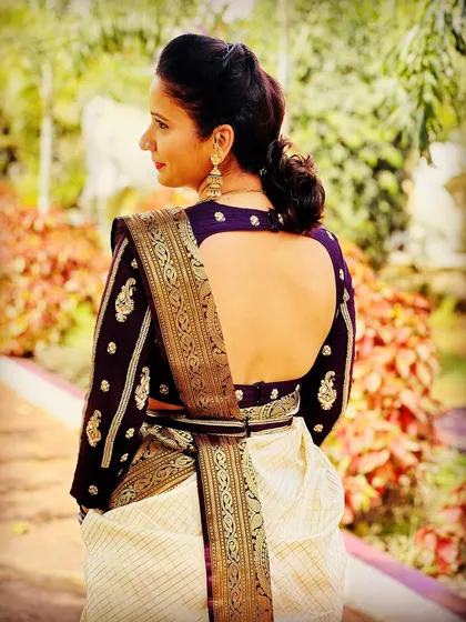 A duplicate image of a client in a deep purple blouse and Kanjeevaram saree.