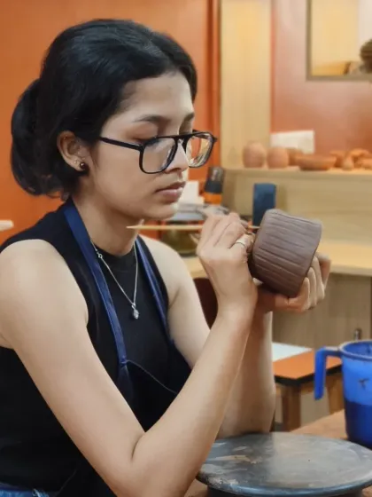 The look of intense focus. This student is meticulously carving lines into her hand-built mug, a project from her second day that already looks studio-worthy.