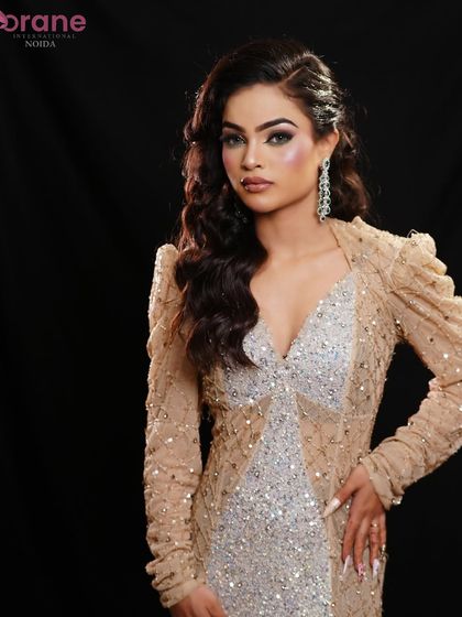 A sophisticated glam look, featuring a sparkling nude gown, smokey eyes, and glitter in the hair for extra sparkle.