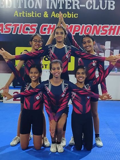 Our star gymnasts strike a powerful pose, showcasing the teamwork and artistry that defines our successful aerobic gymnastics program.
