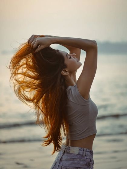 This shot is all about capturing the feeling of freedom and movement by the sea. I caught the model mid-motion as she ran her hands through her hair, with the sunset backlighting her and making her hair glow. It’s a dynamic and liberating image.