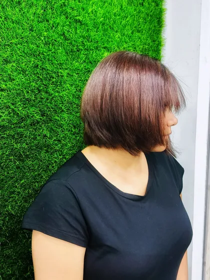 A side profile of my new summer haircut. A great hairstyle is the foundation of any look, and this sleek bob is a versatile and chic choice that complements many different styles.