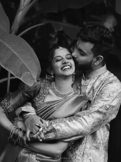 A moment of pure, uninhibited laughter. This black and white engagement photo is timeless, focusing entirely on the couple's joyful connection.