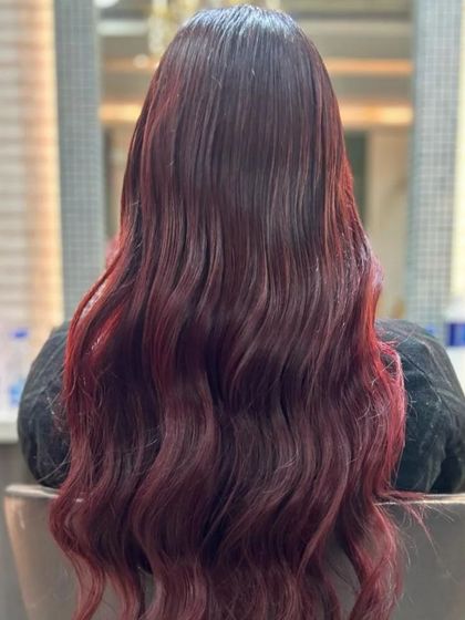 The back view of the red color melt, showcasing the depth and richness of the tones before styling.