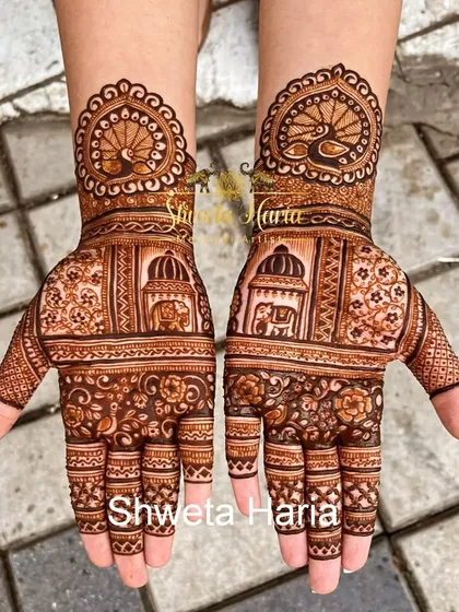 My work often includes classic and royal Indian themes. This traditional henna design showcases intricate architectural elements like palace windows, along with elephant motifs and peacock mandalas at the wrist.