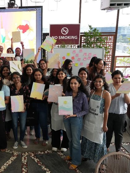 More happy faces and finished canvases from the Meesho team event. The pride in holding up something you created yourself is universal.