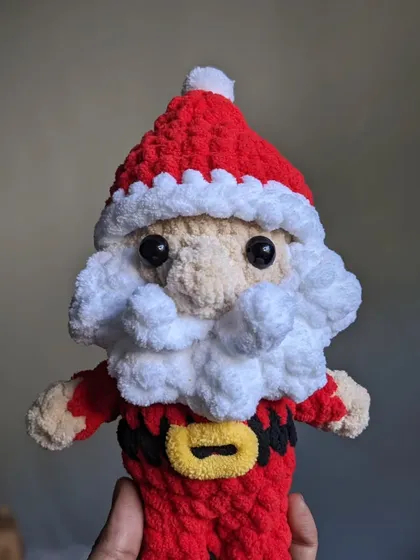A festive Santa Claus doll, perfect for holiday decorations or as a Christmas gift.