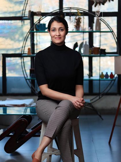 A full-body seated pose that shows more of the environment, perfect for a website's "About Us" page.