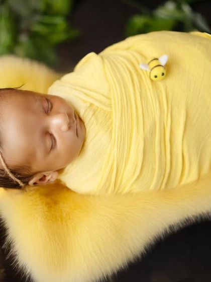 Another peaceful sleeping pose from the honey bee session, with a tiny bee prop resting on the baby's back.