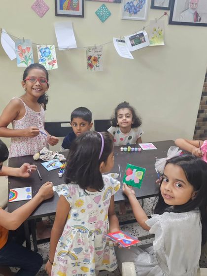 A happy group of young artists working on their painting projects during our Children's Day event. Their enthusiasm is truly infectious.
