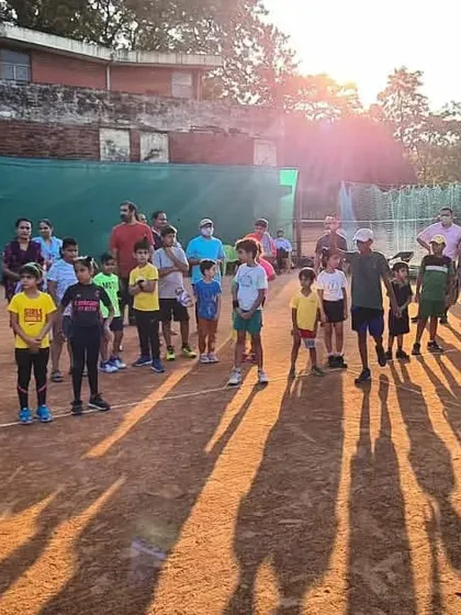 The sun sets on a successful tournament day for my junior players. The long shadows on the clay court mark the end of a day filled with effort and passion.