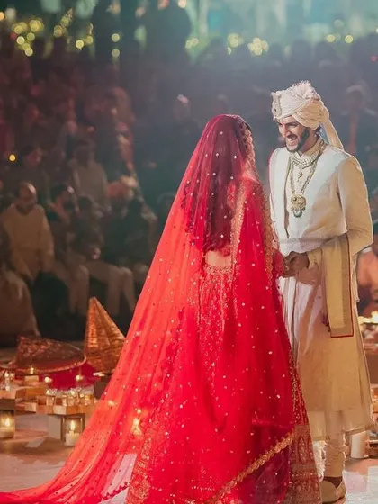 The Varmala is a pinnacle moment. We create the perfect stage for it, ensuring the decor, lighting, and atmosphere amplify the emotion, as seen here with the couple surrounded by hundreds of candles and a sea of guests.