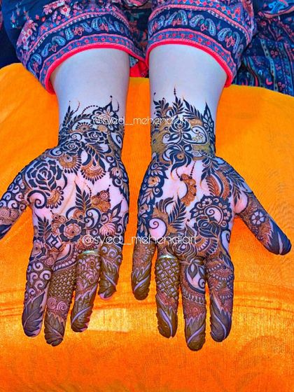 A beautiful party-wear design with a mix of peacock and floral motifs.