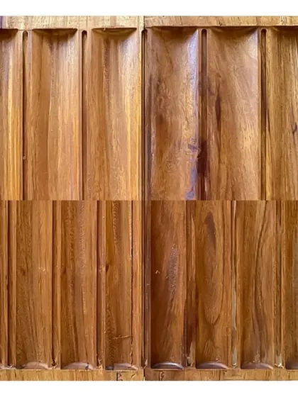 A close-up of sculpted teak wood panels in our workshop. This exploration of texture and form is a key part of our design and execution process.
