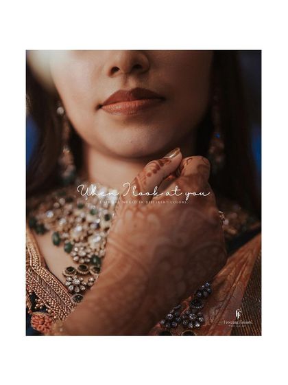 A close-up on the bride's necklace and henna-adorned hand, with the romantic text "When I look at you."