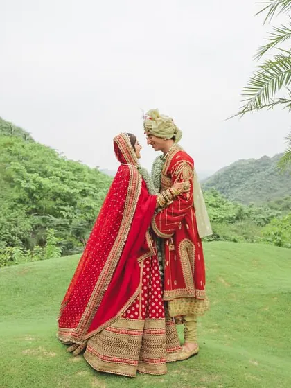 A romantic portrait of the couple amidst the lush green hills of Udaipur. A destination wedding isn't just about the venue, it's about using the stunning natural landscape as your backdrop.