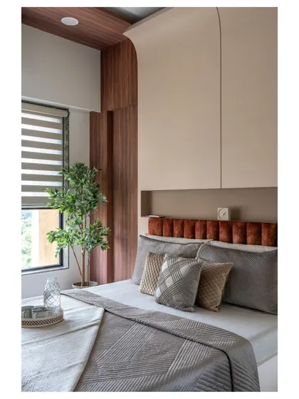 This master bedroom embraces Scandinavian design with its clean lines, expansive windows, and a mix of cozy textures. The curved detail behind the bed adds a soft, organic touch.