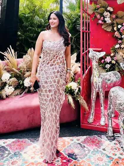 Our signature draped saree dress in sequinned tulle, seen here on a client at an outdoor event.