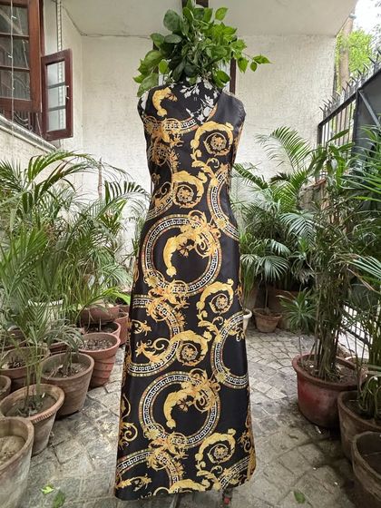 Another angle of the custom baroque print maxi dress. The V-neckline and sleeveless design create a classic and elegant silhouette, perfect for a variety of occasions.