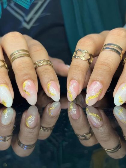 A beautiful and artistic design with a sheer base, a mix of white and pink marbling, and delicate gold foil accents.