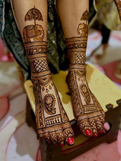 A royal-themed foot design featuring majestic elephants with howdahs and paisley motifs.