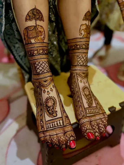 A royal-themed foot design featuring majestic elephants with howdahs and paisley motifs.