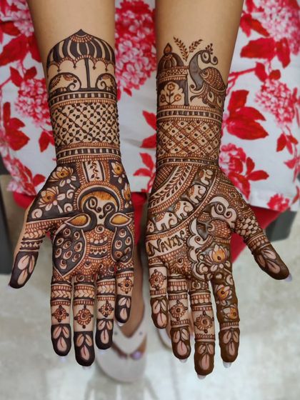 An engagement henna design filled with celebratory motifs. It includes peacocks, elephants, and a traditional umbrella, telling a beautiful story.