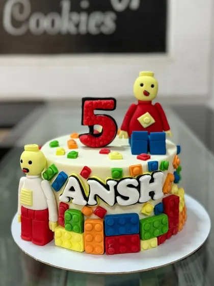 A colorful Lego-themed cake perfect for a 5th birthday. This design features edible Lego blocks and figures, bringing a world of creative fun to the party.