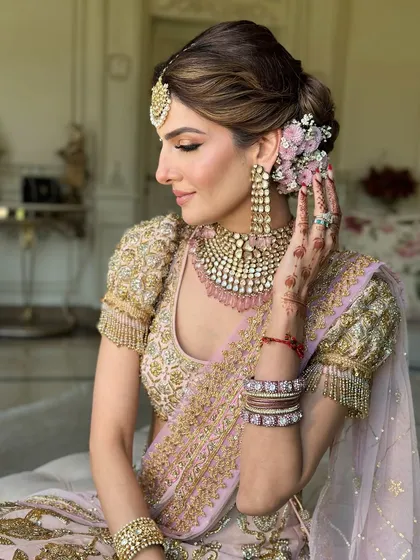The bride's radiant smile, with her beautiful floral bun adding to the romantic wedding day look.