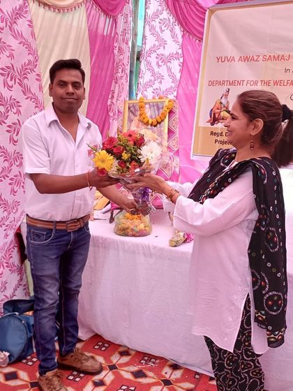 Receiving a floral welcome at the community event. These moments reflect the mutual respect and collaborative spirit that make our NGO events so successful and fulfilling.