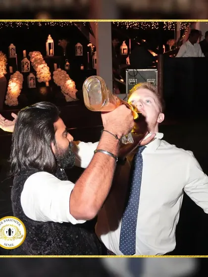 Pouring a drink directly for a guest from a unique bottle. This is what we mean by interactive service, breaking the barrier between the bartender and the party.