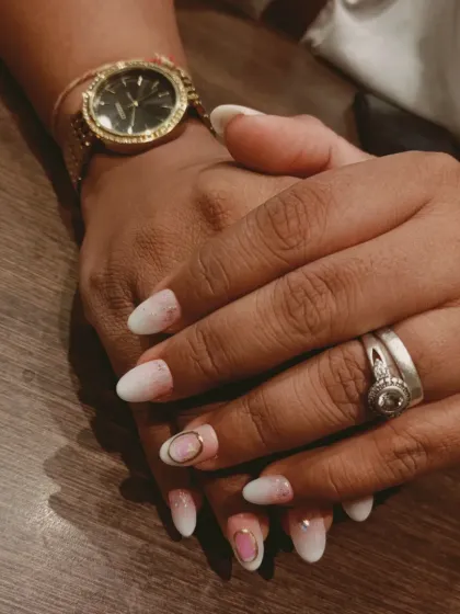 A soft and delicate baby ombre or "boomer" nail, blending from a natural pink base to a soft white tip, with a subtle gold accent.