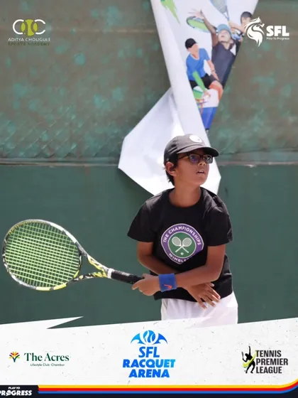 A young player wearing a Wimbledon shirt shows his readiness and focus during a tournament. We encourage our students to dream big and aim for the world's greatest stages.
