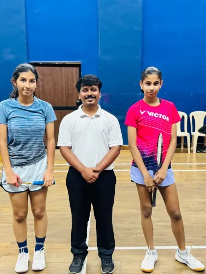 Two young competitors with a tournament official at the WCG Women's Special Event.