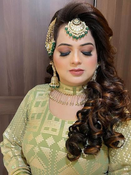 A close-up of the bridal makeup, showcasing the dramatic eye makeup and perfectly sculpted features.