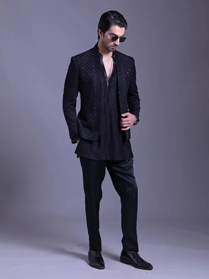 A full-length view of the black textured Indo-Western outfit. The clean silhouette and subtle detailing create a look that is both modern and elegant.