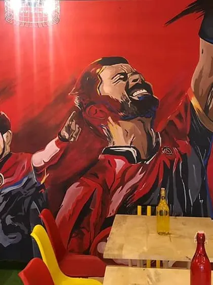Our tribute to the legends of Royal Challengers Bangalore. This mural is the centerpiece of the cafe and a huge draw for cricket fans.