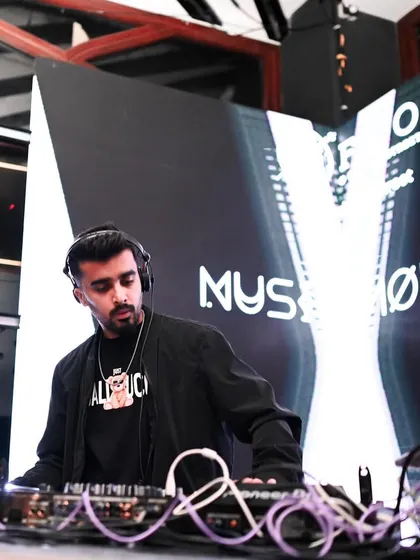 A focused shot of me at the console with a clean, white background, highlighting the artist and the equipment.