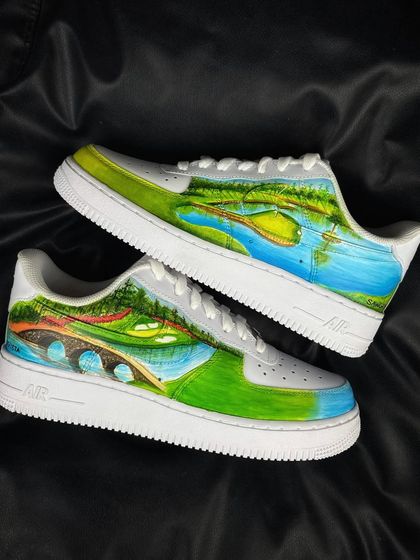 The full pair of Tiger Woods custom sneakers on a black background.