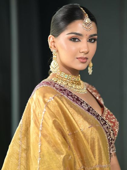 A three-quarter view that highlights the structure and contour of the face, along with the sharp, defined eyeliner that elongates the eyes.