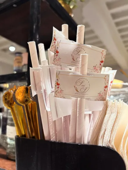 A collection of custom straws and stirrers, ready for service. These small details elevate the look of each drink and reinforce the event's theme.